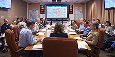 a group of leaders meeting inside CDC's Emergency Operations Center
