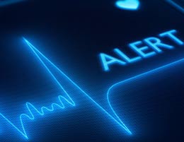 A heart monitoring machine with the word “ALERT” on it