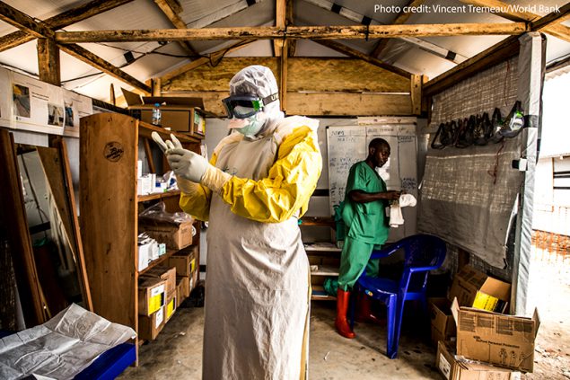 An Ebola worker putting on personal protective equipment